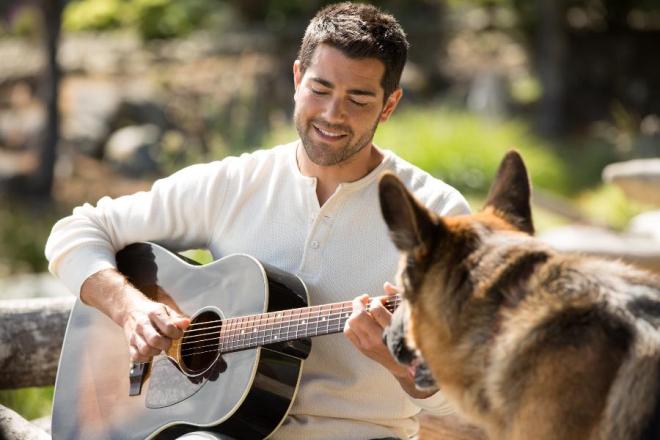 Dog + guitar + hot guy = winning photo.